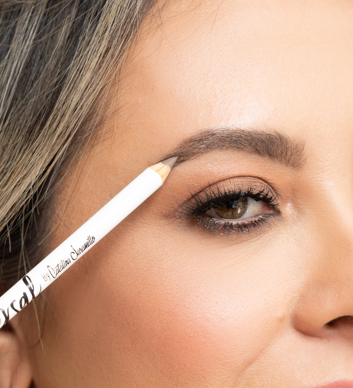 Woman using the universal eyebrow pencil